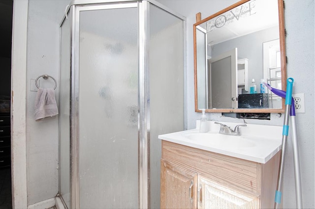 bathroom with vanity and a shower with door