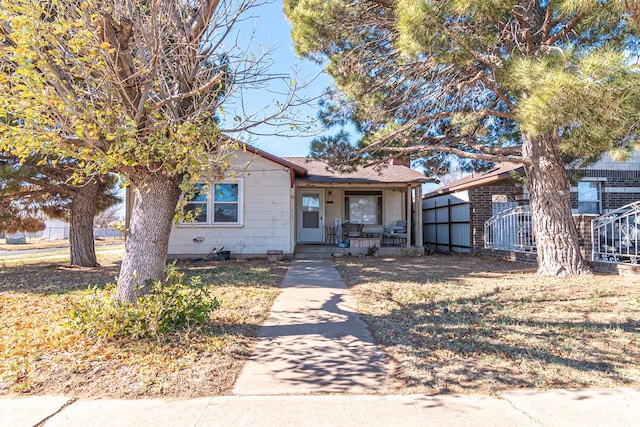 view of front of house with covered porch and a front yard