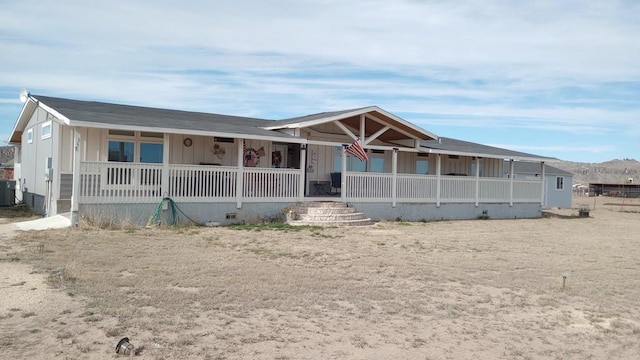 view of front facade featuring a porch and central air condition unit