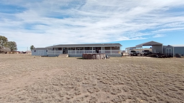 view of front of property with a carport and a sunroom