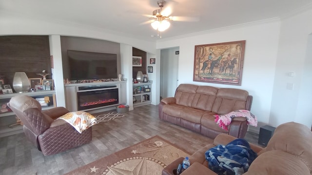 living room with crown molding, ceiling fan, and hardwood / wood-style flooring