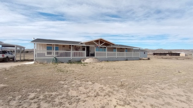 view of front facade featuring covered porch and a carport