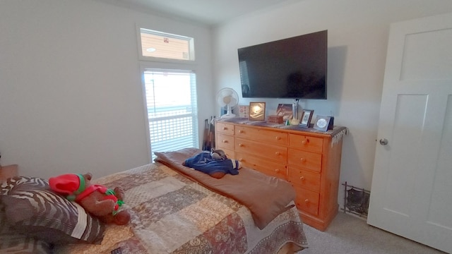 bedroom featuring light carpet