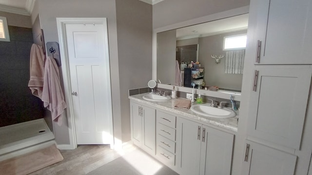 bathroom featuring hardwood / wood-style floors, vanity, and ornamental molding