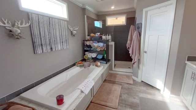 bathroom featuring separate shower and tub, crown molding, and vanity