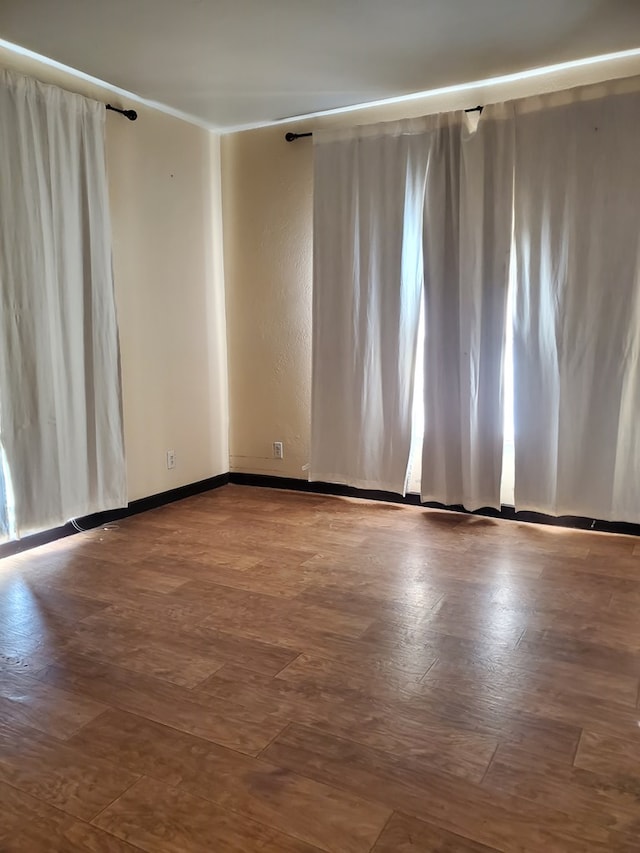 unfurnished room featuring hardwood / wood-style flooring