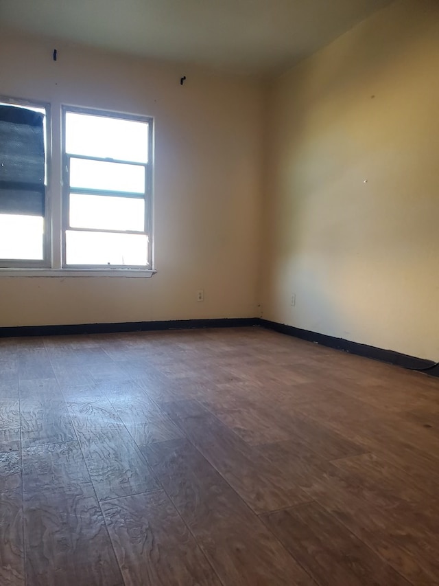 unfurnished room featuring dark hardwood / wood-style floors