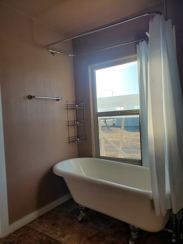 bathroom with a tub to relax in