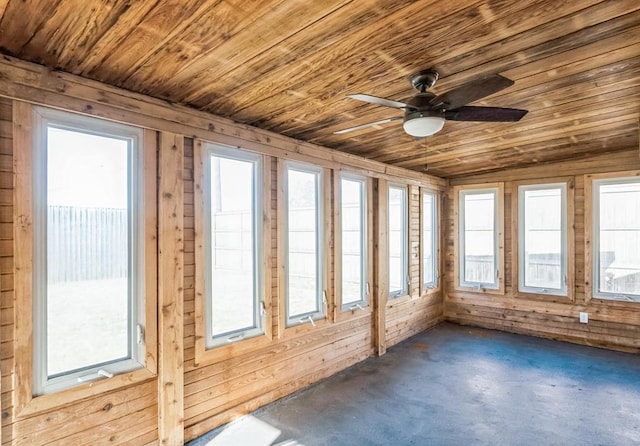 unfurnished sunroom with plenty of natural light, ceiling fan, and wooden ceiling