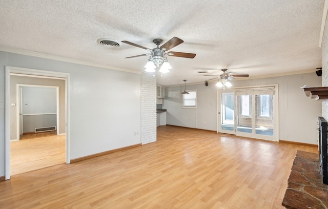 unfurnished living room featuring ceiling fan, light wood-type flooring, crown molding, and a brick fireplace