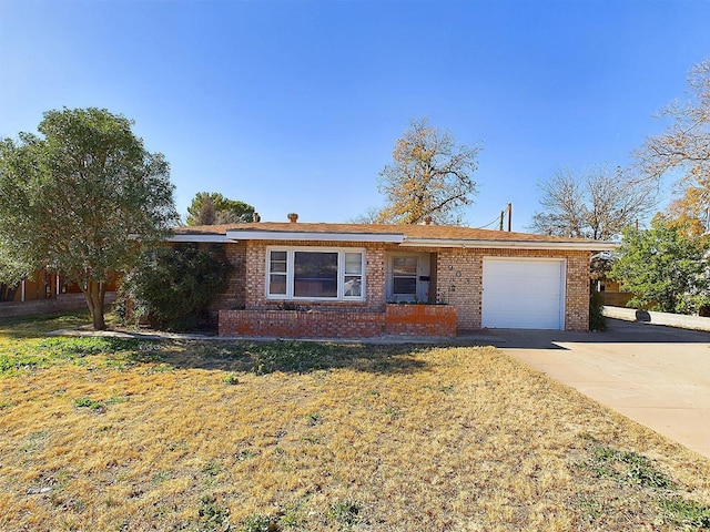 ranch-style home with a front lawn and a garage