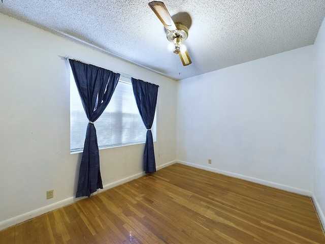 spare room with ceiling fan, wood-type flooring, and a textured ceiling