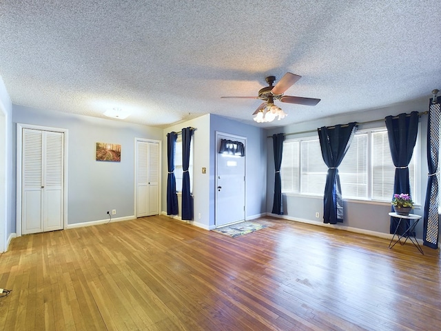 empty room with ceiling fan and hardwood / wood-style flooring