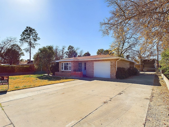 ranch-style house featuring a garage, a front lawn, and a carport