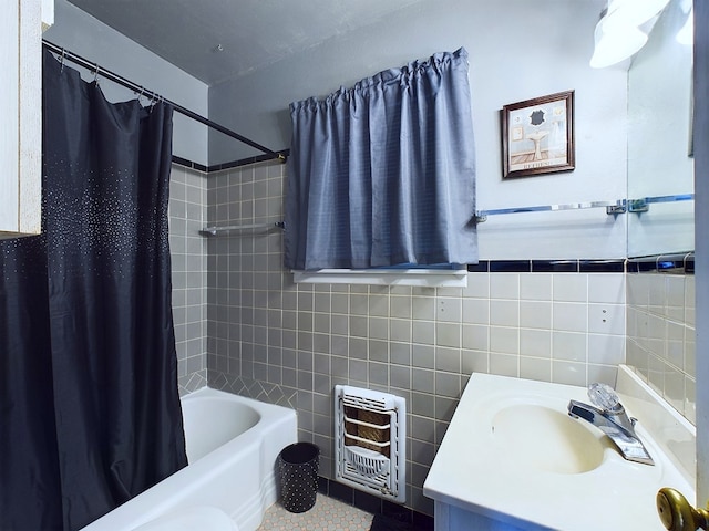 bathroom featuring vanity, tile walls, tile patterned flooring, shower / bath combination with curtain, and heating unit