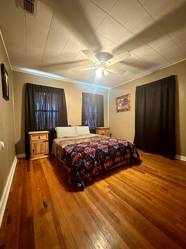 bedroom featuring ceiling fan and hardwood / wood-style floors