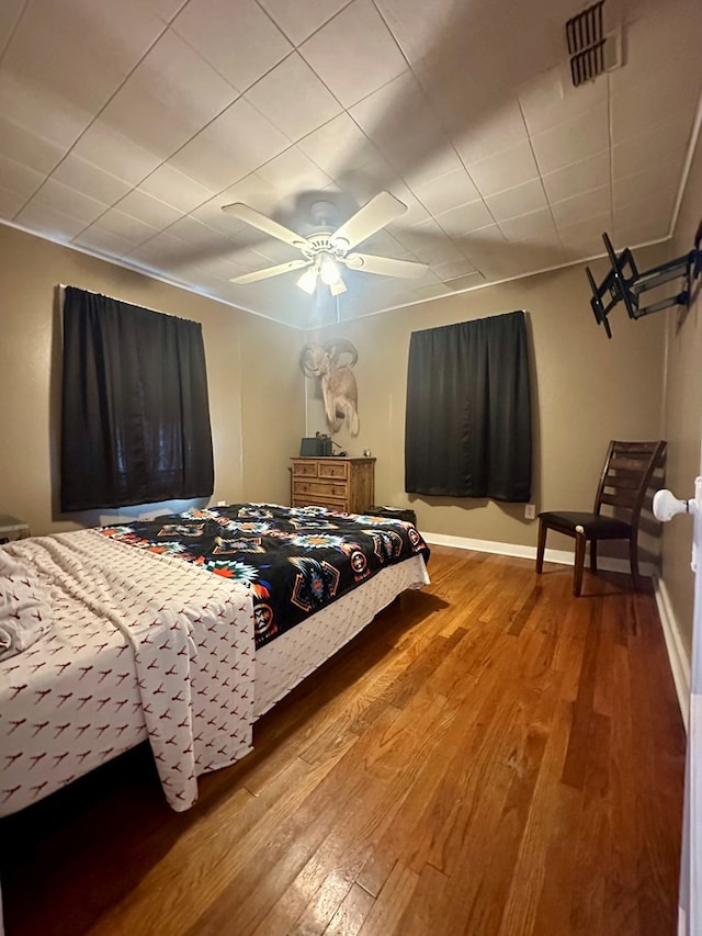 bedroom with hardwood / wood-style flooring and ceiling fan