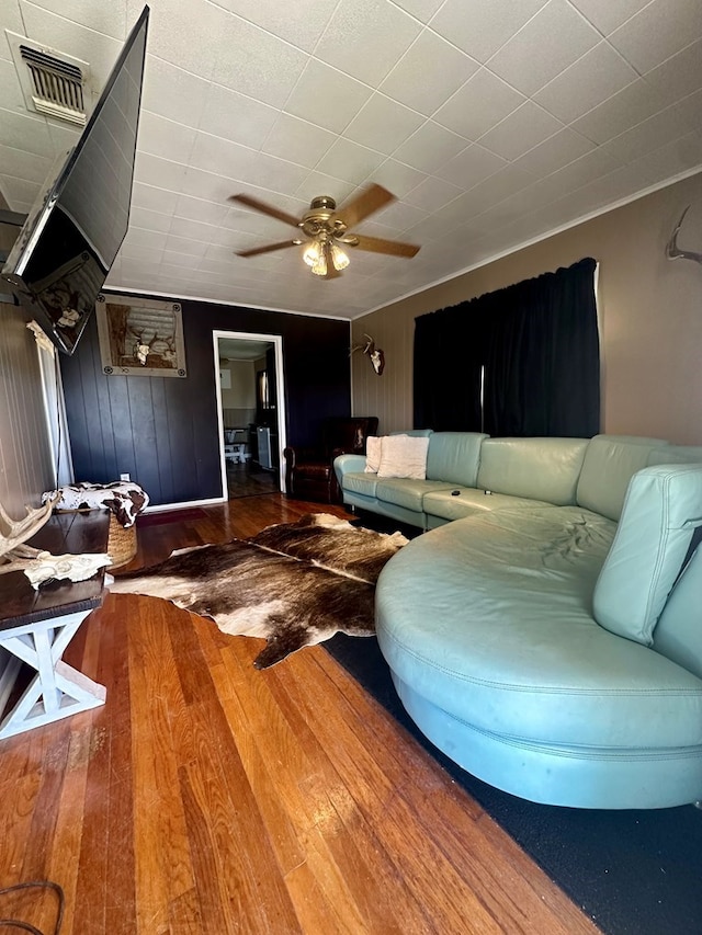 living room featuring ceiling fan and wood-type flooring