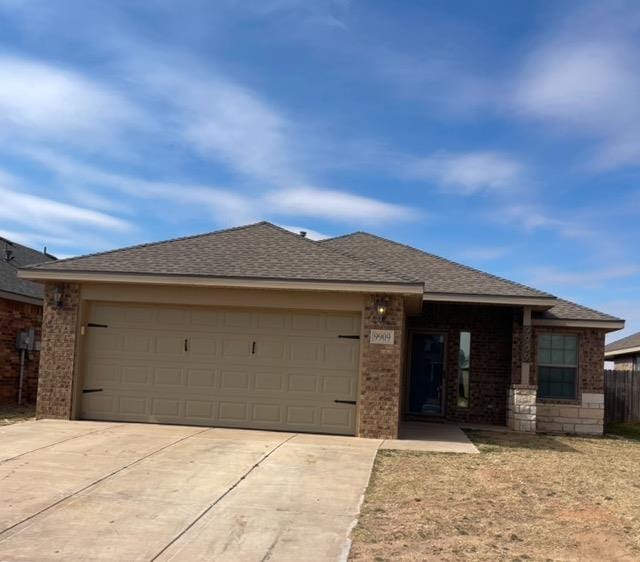 view of front of property featuring brick siding, a shingled roof, fence, a garage, and driveway