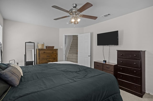 bedroom featuring light colored carpet and ceiling fan