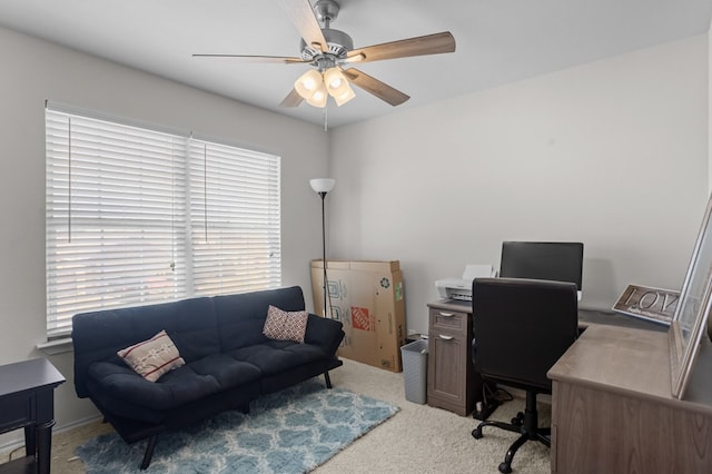 carpeted office featuring ceiling fan