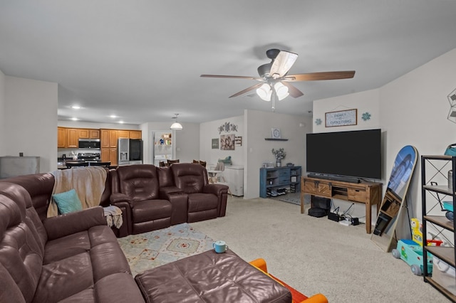 living area with light carpet and ceiling fan