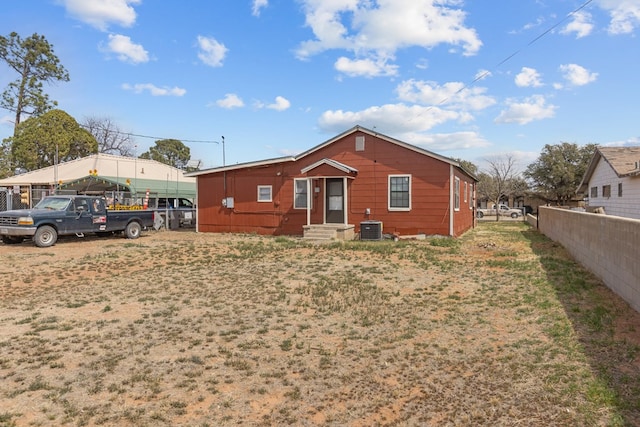 back of property featuring cooling unit, fence, and entry steps