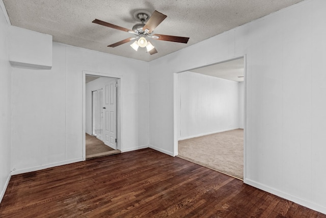 spare room with a textured ceiling, wood finished floors, and a ceiling fan