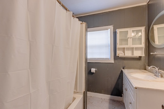 bathroom featuring marble finish floor, shower / bath combo, vanity, and baseboards