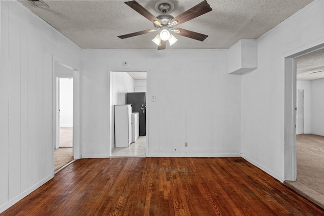 empty room with ceiling fan, a textured ceiling, and wood finished floors