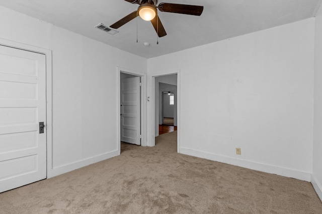 unfurnished bedroom featuring carpet floors, baseboards, and visible vents