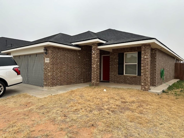 single story home with a garage and a front yard