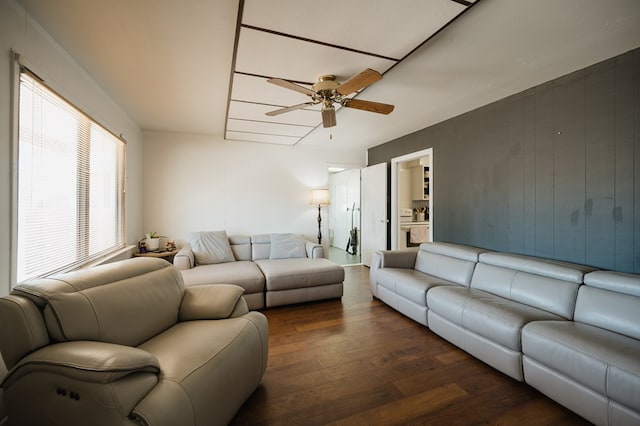 living room featuring dark hardwood / wood-style floors and ceiling fan