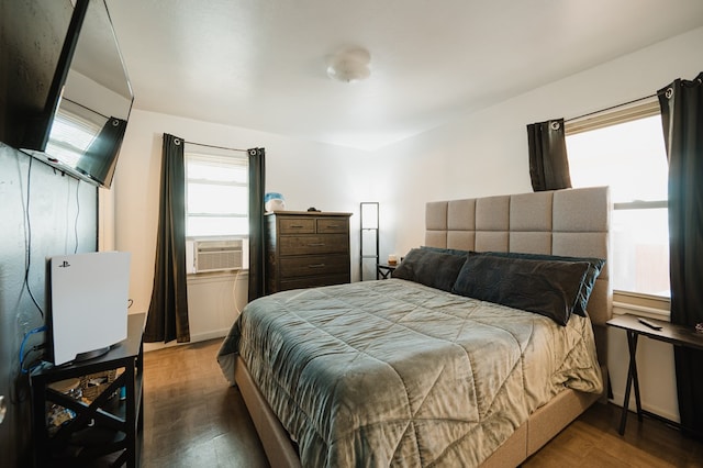 bedroom with cooling unit and dark wood-type flooring