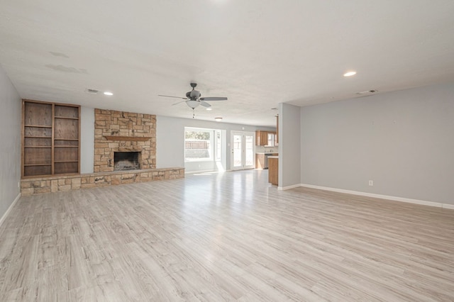 unfurnished living room with visible vents, baseboards, light wood-style flooring, and a fireplace