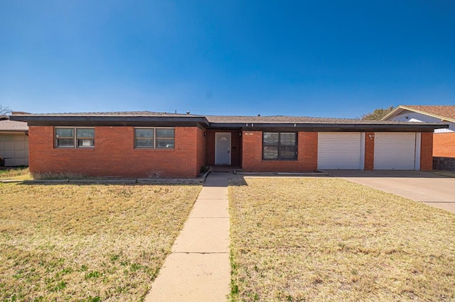 single story home featuring a garage, brick siding, concrete driveway, and a front yard