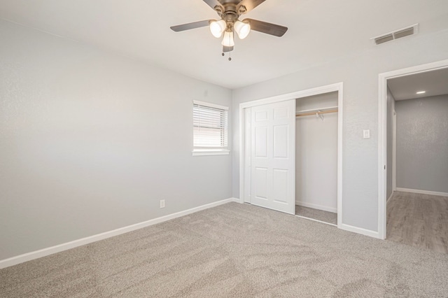 unfurnished bedroom featuring a closet, baseboards, visible vents, and carpet floors