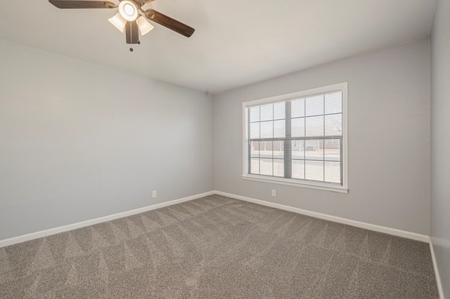 unfurnished room featuring carpet flooring, a ceiling fan, and baseboards