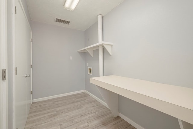 clothes washing area with visible vents, baseboards, light wood-type flooring, laundry area, and hookup for a washing machine