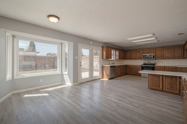 kitchen featuring visible vents, stainless steel appliances, light countertops, and light wood-style floors