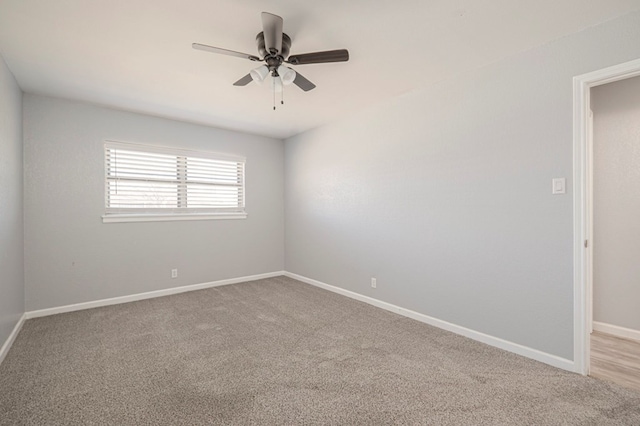 spare room featuring baseboards, carpet floors, and a ceiling fan