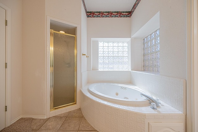 bathroom featuring plus walk in shower and tile patterned floors