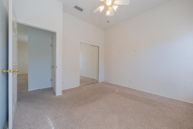 unfurnished bedroom featuring light carpet, ceiling fan, and a closet