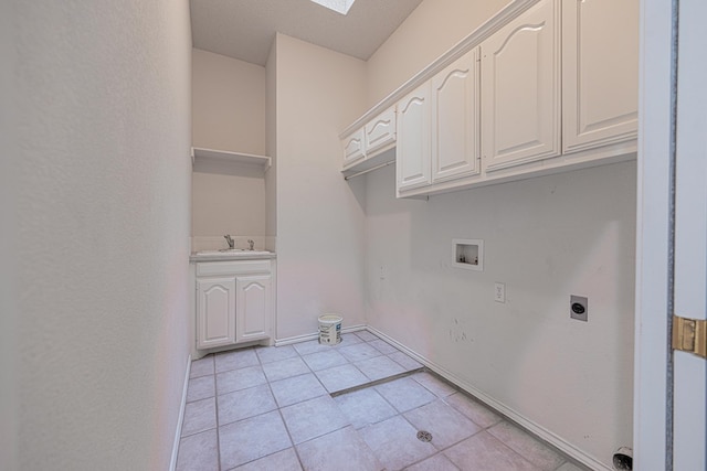 washroom featuring light tile patterned flooring, sink, cabinets, hookup for a washing machine, and electric dryer hookup