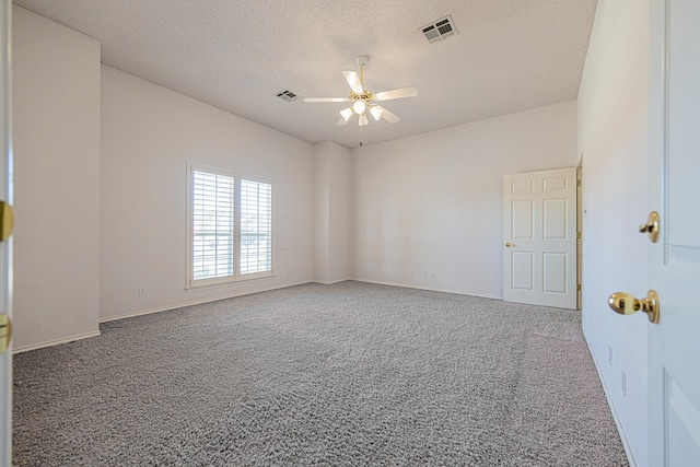 empty room featuring ceiling fan, carpet flooring, and a textured ceiling