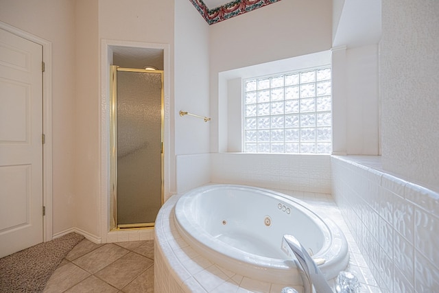 bathroom with separate shower and tub and tile patterned flooring