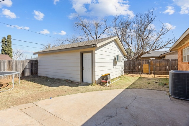 exterior space featuring a trampoline, central AC unit, and fence