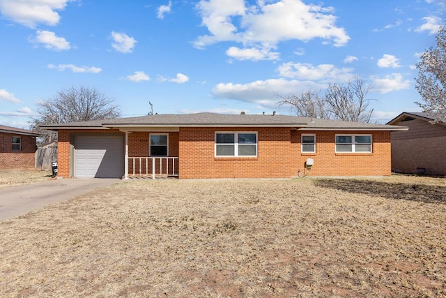 ranch-style house featuring a garage, brick siding, and driveway