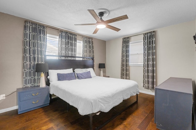 bedroom featuring a textured ceiling, baseboards, and hardwood / wood-style floors