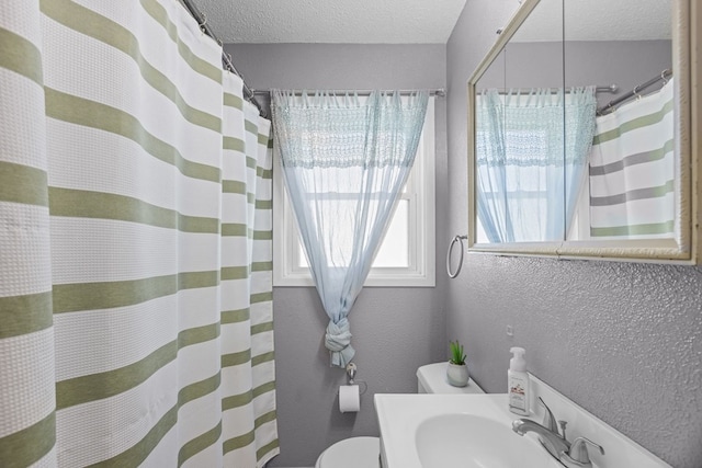 full bathroom with a shower with curtain, toilet, a textured ceiling, vanity, and a textured wall